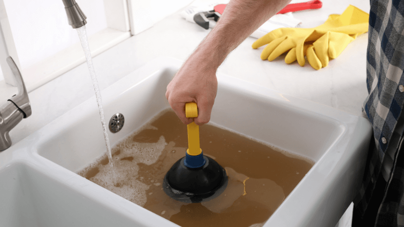 clogged drain being fixed