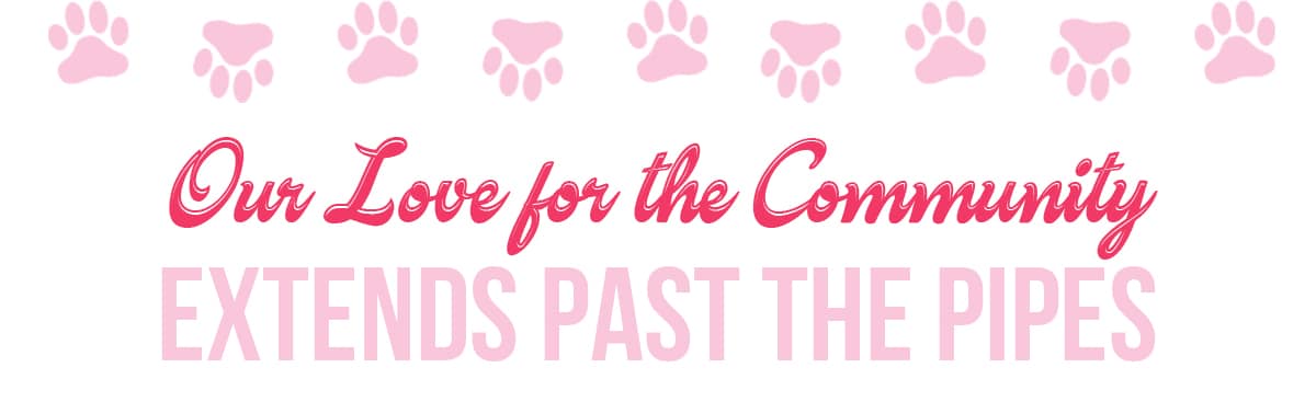 Pink paw prints above the text "Our Love for the Community Extends Past the Pipes" in bold pink and red fonts on a white background.