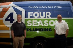 %Title% | Four Seasons Plumbing Two men stand in front of a Four Seasons Plumbing van with a logo and the slogan "The right call any time of year" visible on the side.