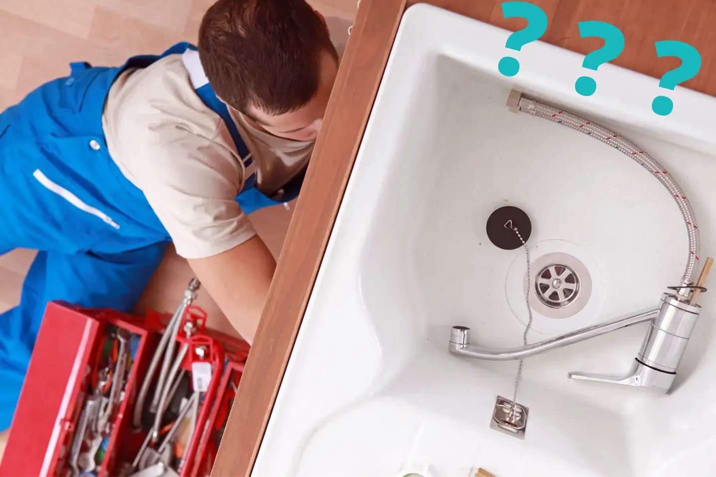 Plumber in blue overalls works under a kitchen sink with pipes visible in the basin and a red toolbox nearby; three question marks are added above the sink.